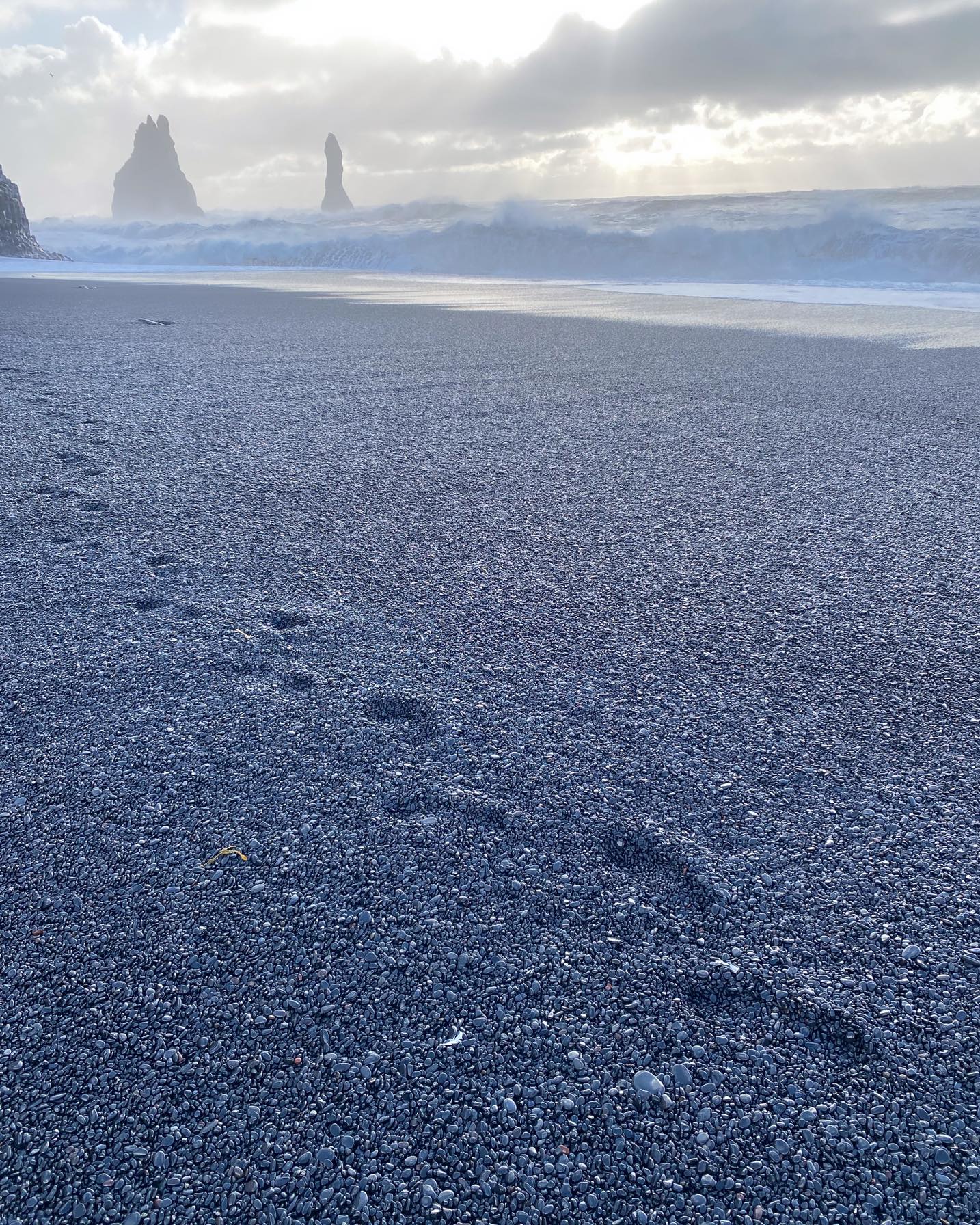 Footsteps on volcanic beach
